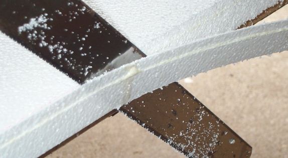 Photo of cutting styrofoam using a hand saw